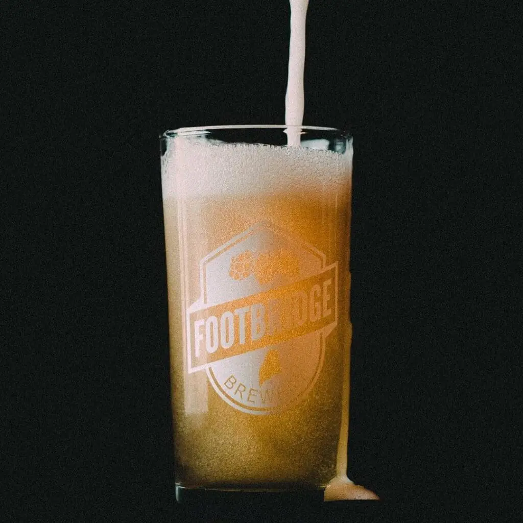 Beer pouring into a Footbridge Brewery glass