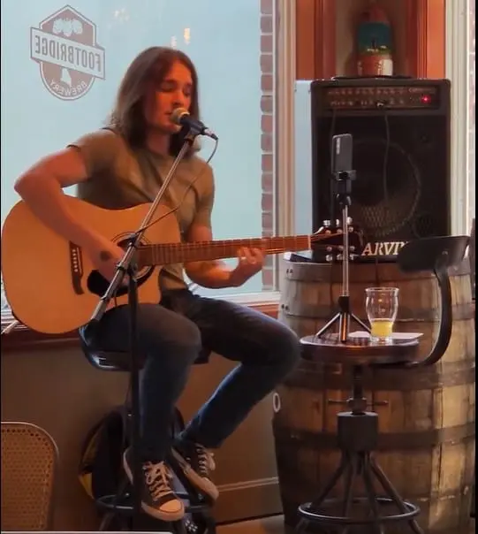 Marko playing guitar at a live event at Footbridge Brewery & BBQ restaurant