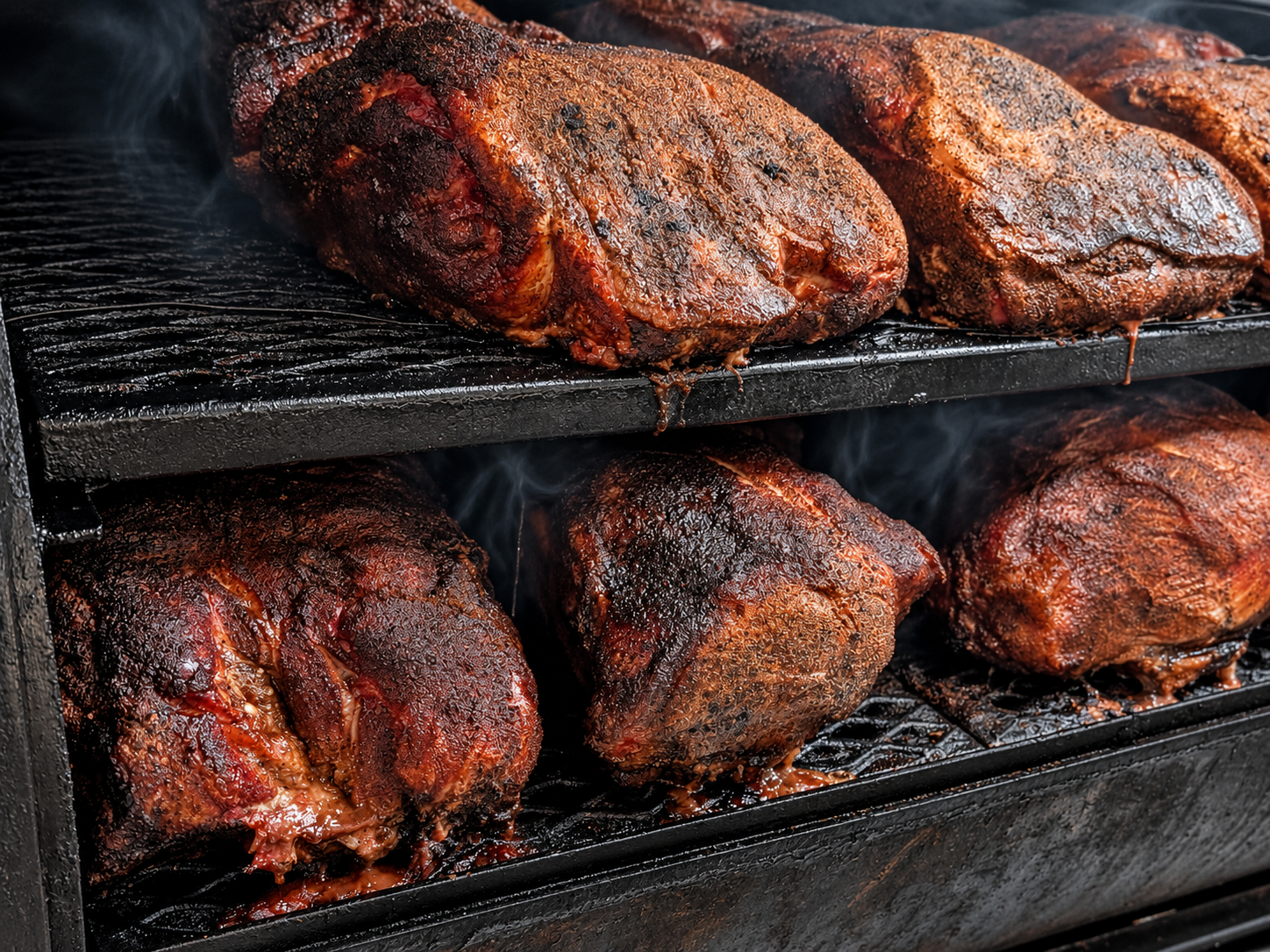 Pork shoulders smoking inside the smoker at Footbridge Brewery & BBQ.